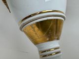 a white vase with a gold trim on it