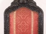 a red and gold chair with a lion head on the back