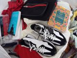 a box full of clothes and shoes and a book