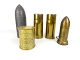 several different types of brass bullet shells are lined up on a white surface