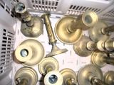 a lot of brass knobs and handles in a basket