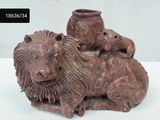 a statue of a lion and a lioness laying on a table