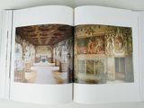 an open book with a picture of a room in it