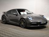 the porsche 911 gts is parked in a garage with a checkered floor