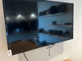 a flat screen tv mounted on a wall in a room
