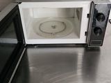 a microwave that is sitting on a table in the kitchen