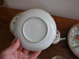 a person holding a white bowl on a wooden table
