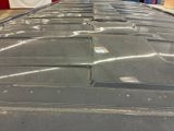 a close up of a flat tire on a conveyor belt