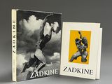 two books on a table with a picture of a man on a skateboard