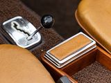 an image of a car ' s interior with a gear box and a shift button