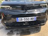 a black car that is parked in a parking lot