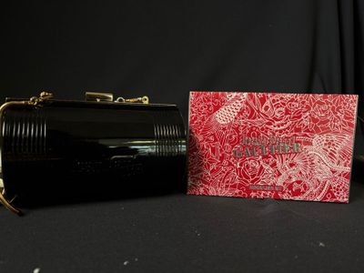 an image of a red and black purse and a red and white box