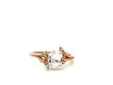 a close up of a ring with an oval white topaz stone