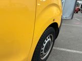 a yellow van that is parked in a parking lot