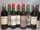 six bottles of wine are lined up in a row on a table