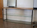 a glass shelf with a computer on top of it