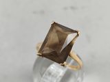a close up of a ring with a brown stone in it