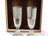 two empty wine glasses in a box on a white surface