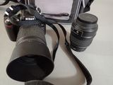 a camera and a lens on a table next to a camera case