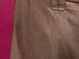 the back of a man ' s pants with a belt on a pink background