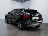 the rear end of a black suv parked in a garage