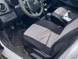 the interior of a car with the door open and the driver ' s seat down
