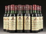 six bottles of wine are lined up in a row on a table