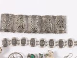several pieces of silver jewelry including a bracelet, broochle, and earrings