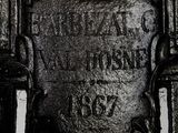 a close up of a metal plaque with a cross on it