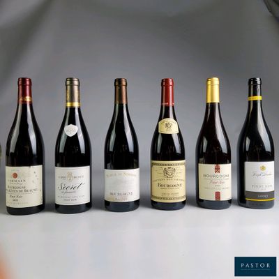 several bottles of wine are lined up on a table