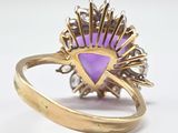 an image of a gold ring with a purple stone in the center