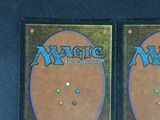 two decks of magic the gathering are on display on a table