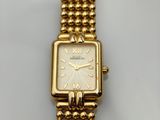 a close up of a watch on a white surface with a white background