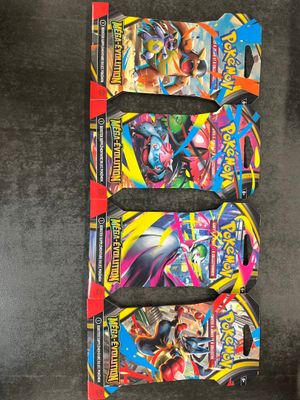 a group of four pokemon trading cards on a table