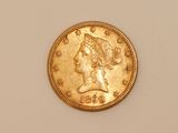 a close up of a gold coin with a woman ' s head on it
