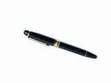 a pen that is laying on top of a white surface