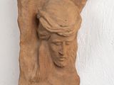 a clay sculpture of a man with a crown on his head