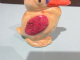 a figurine of a bird sitting on a table