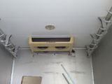 a small air conditioner in the corner of a room
