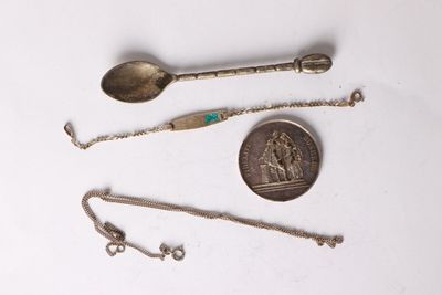 a silver spoon, a silver spoon, and a silver spoon on a white surface