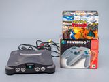 a nintendo 64 game console next to a box of nintendo 64 games