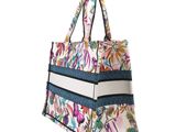 an image of a multicolored floral print bag on a white background