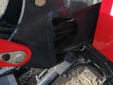 a close up of a red and black tractor with a red seat
