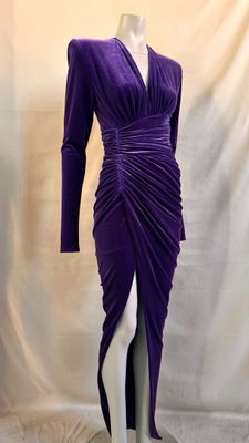 the mannequin is wearing a purple dress with long sleeves