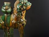 statue of a man on a horse with a hat and a top hat