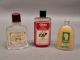 three bottles of alcohol sitting next to each other on a table