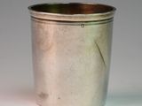a silver cup that is sitting on a table