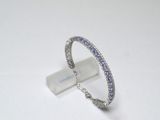 silver ring with blue and white stones on a white surface
