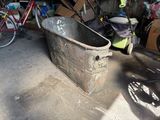 an old bathtub in a garage with a bicycle in the background