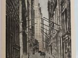 an old picture of a city street with buildings and a horse drawn carriage